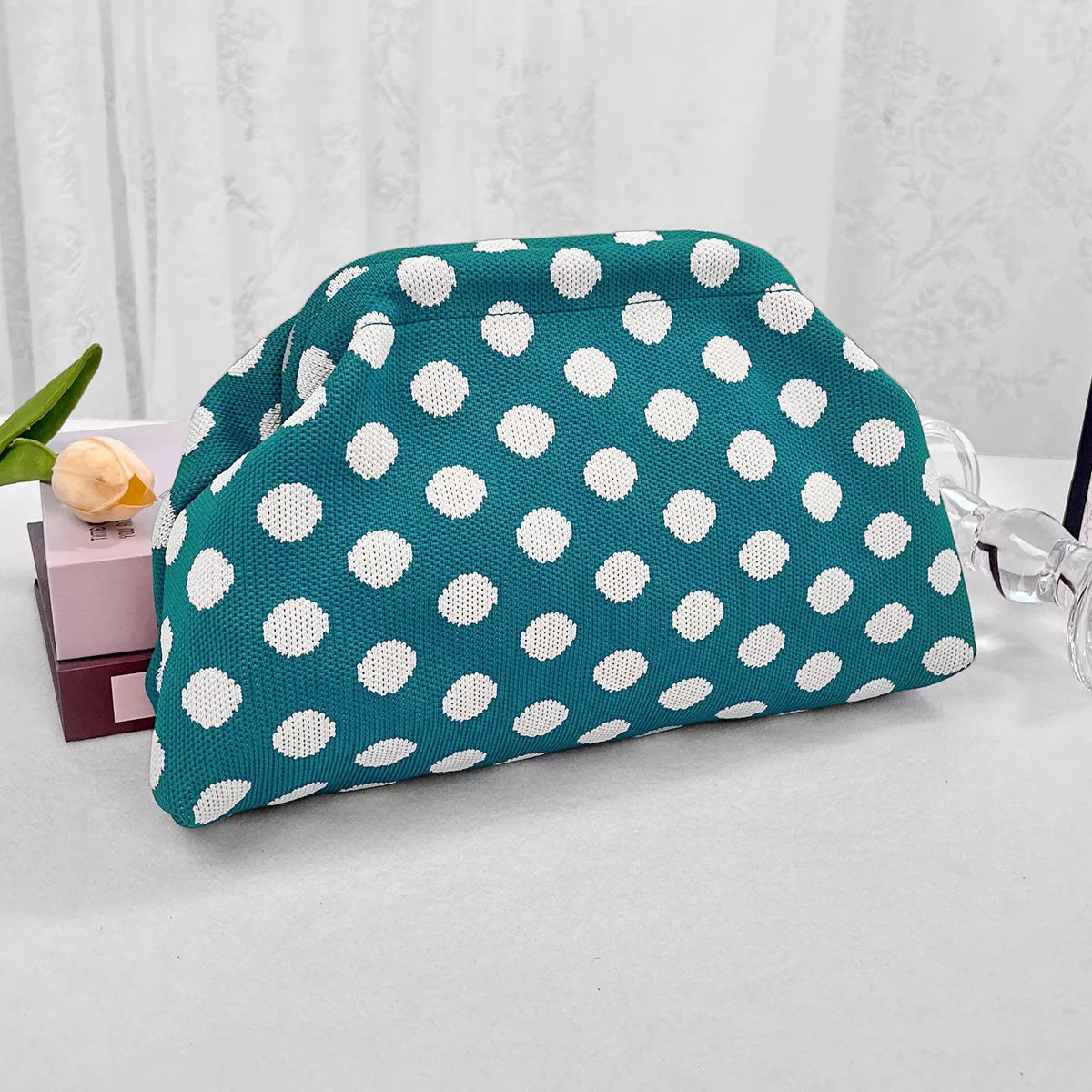Turquoise knit polka-dot clutch with white dots