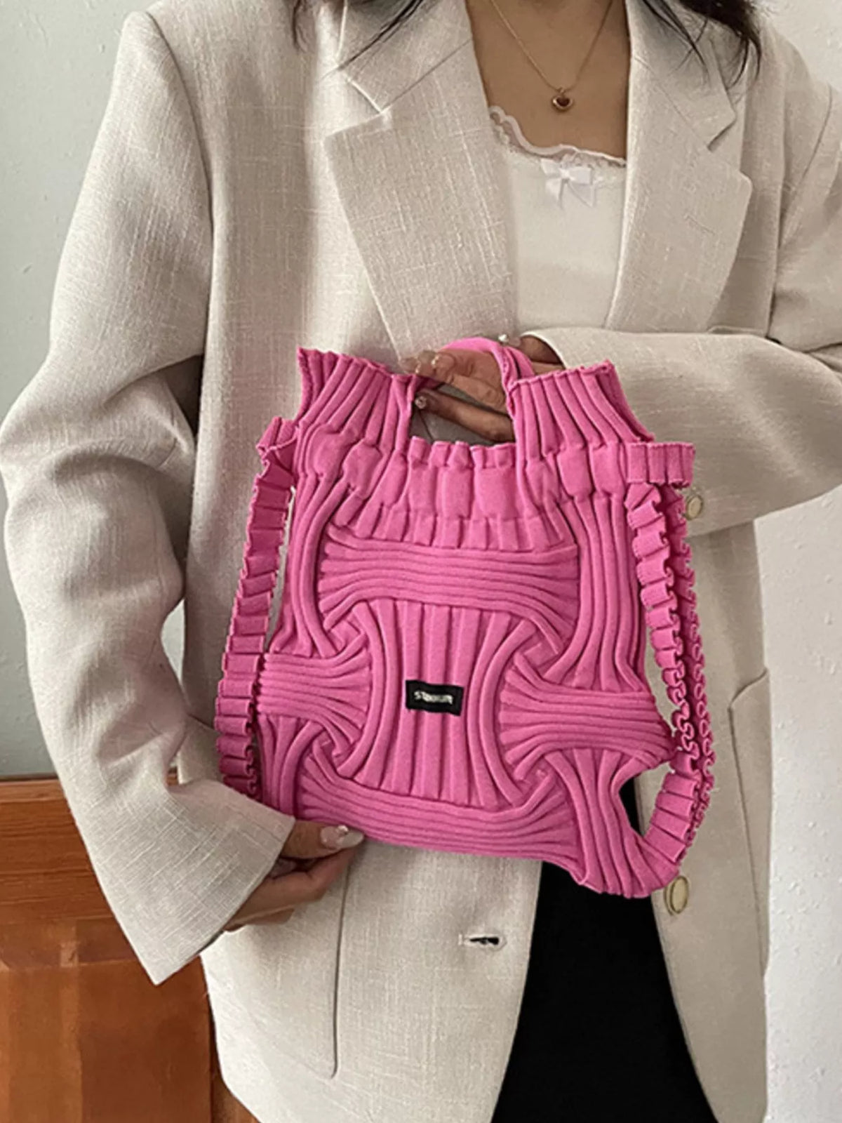Rose red knitted backpack bag with top handles, front pocket knit, black logo patch