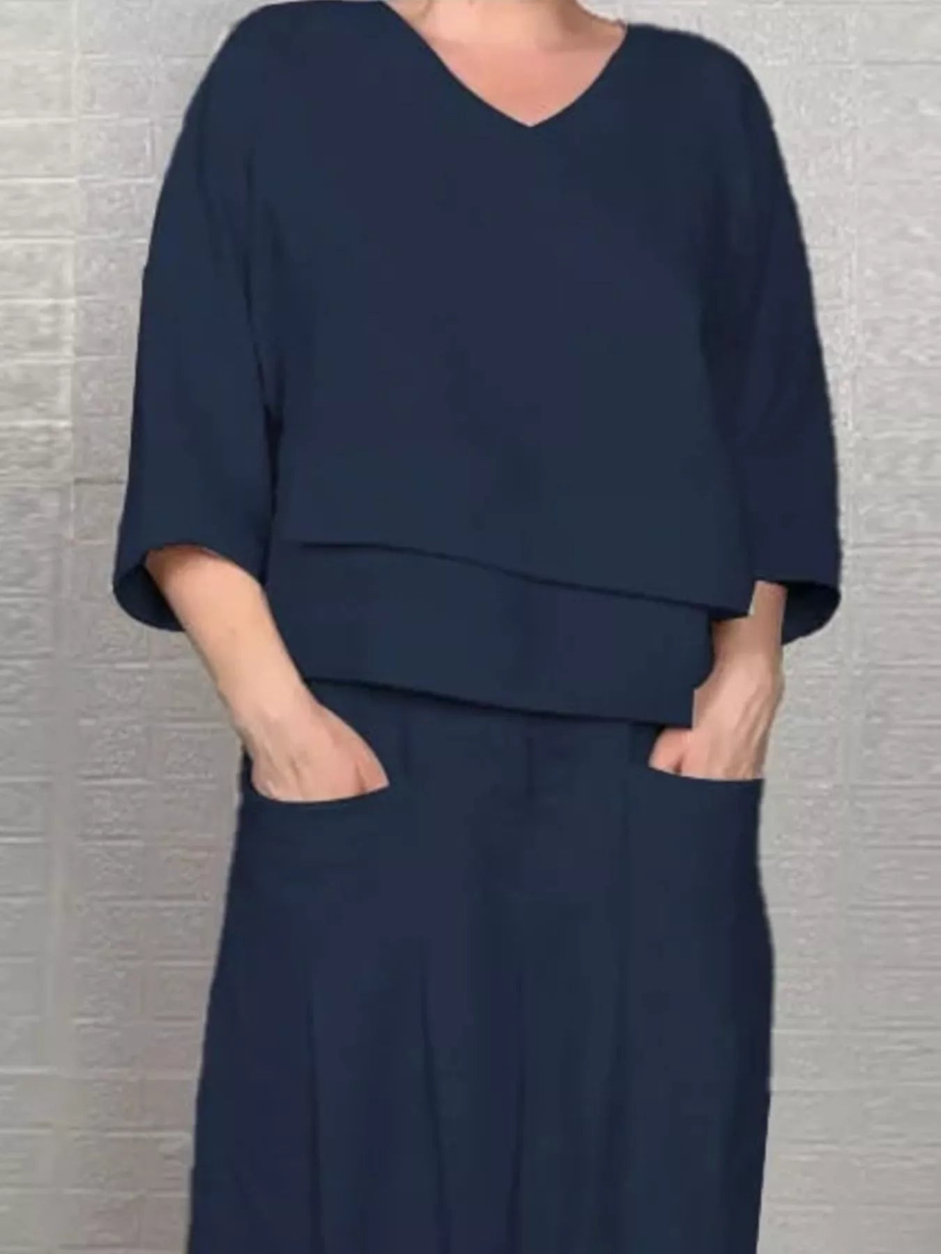 Navy v-neck long sleeve top and wide-leg pants set, draped over waist