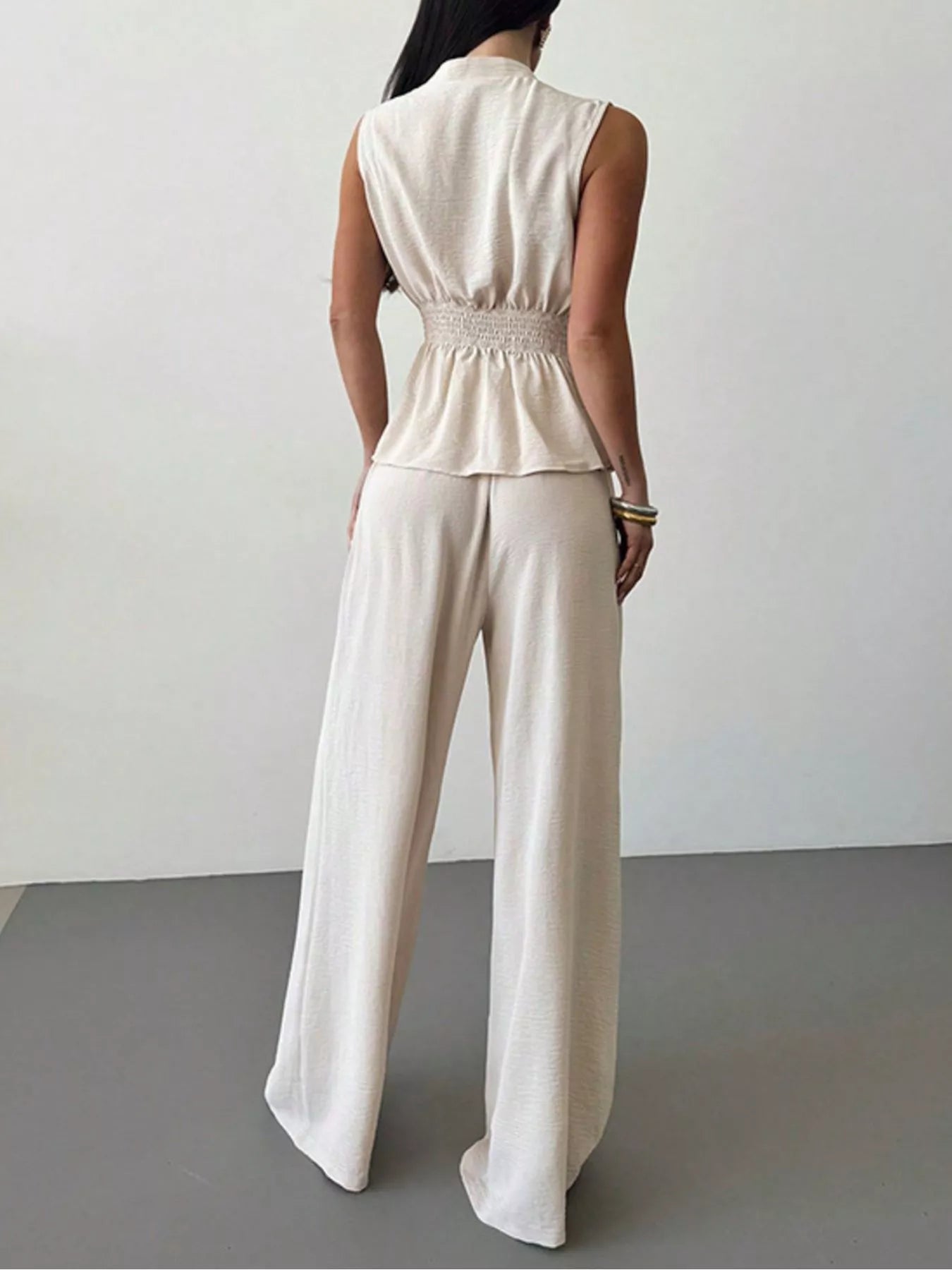 White sleeveless wrap-style top and wide-leg pants set, gathered back waist, wide legs