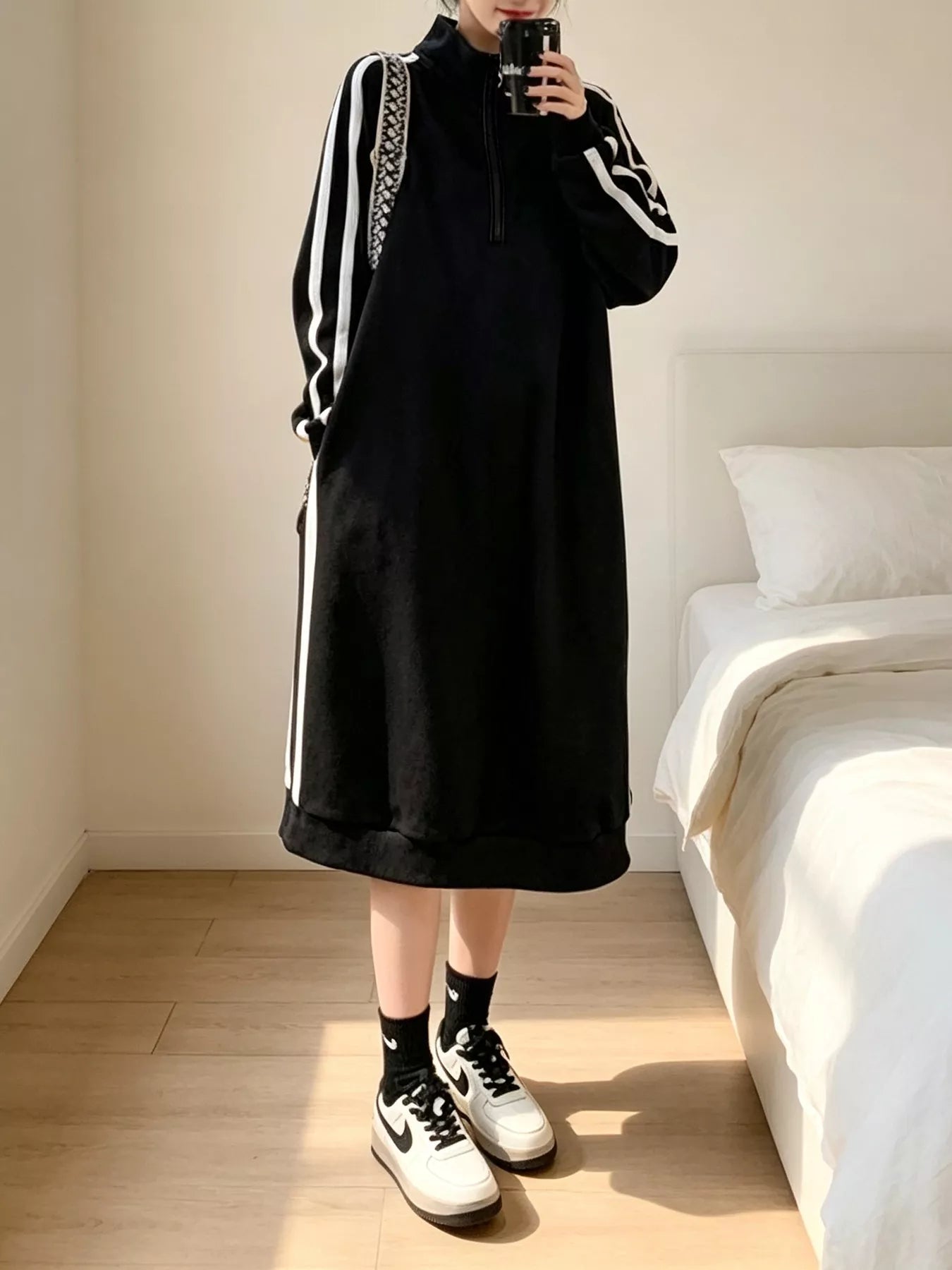 Black quarter-zip mock-neck midi sweatshirt dress with white side stripe piping, long sleeves