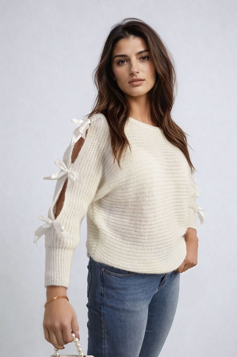 "Chunky knitted top with cut-out tie bow sleeve detail in beige, perfect for cozy winter wear."