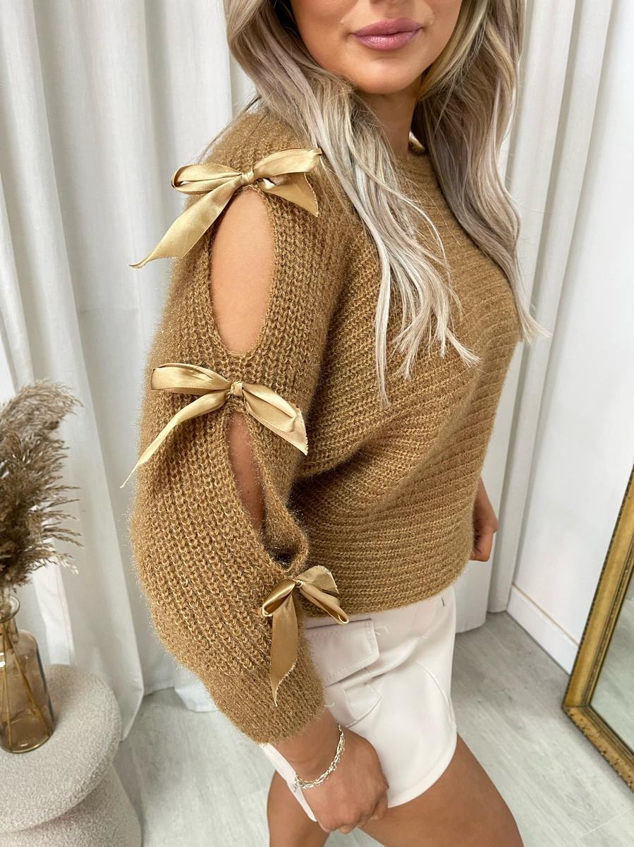 "Chunky knitted top with cut-out tie bow sleeve detail in beige, perfect for cozy winter wear."