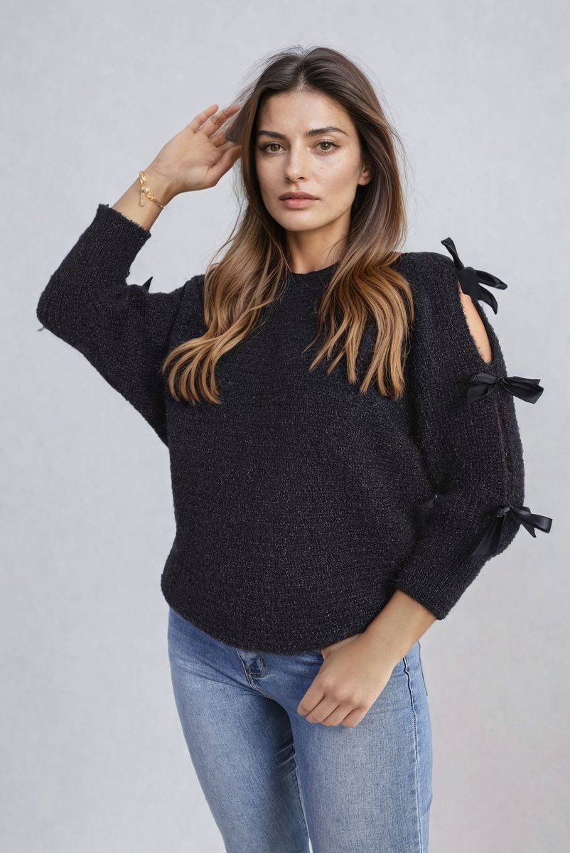 "Chunky knitted top with cut-out tie bow sleeve detail in beige, perfect for cozy winter wear."