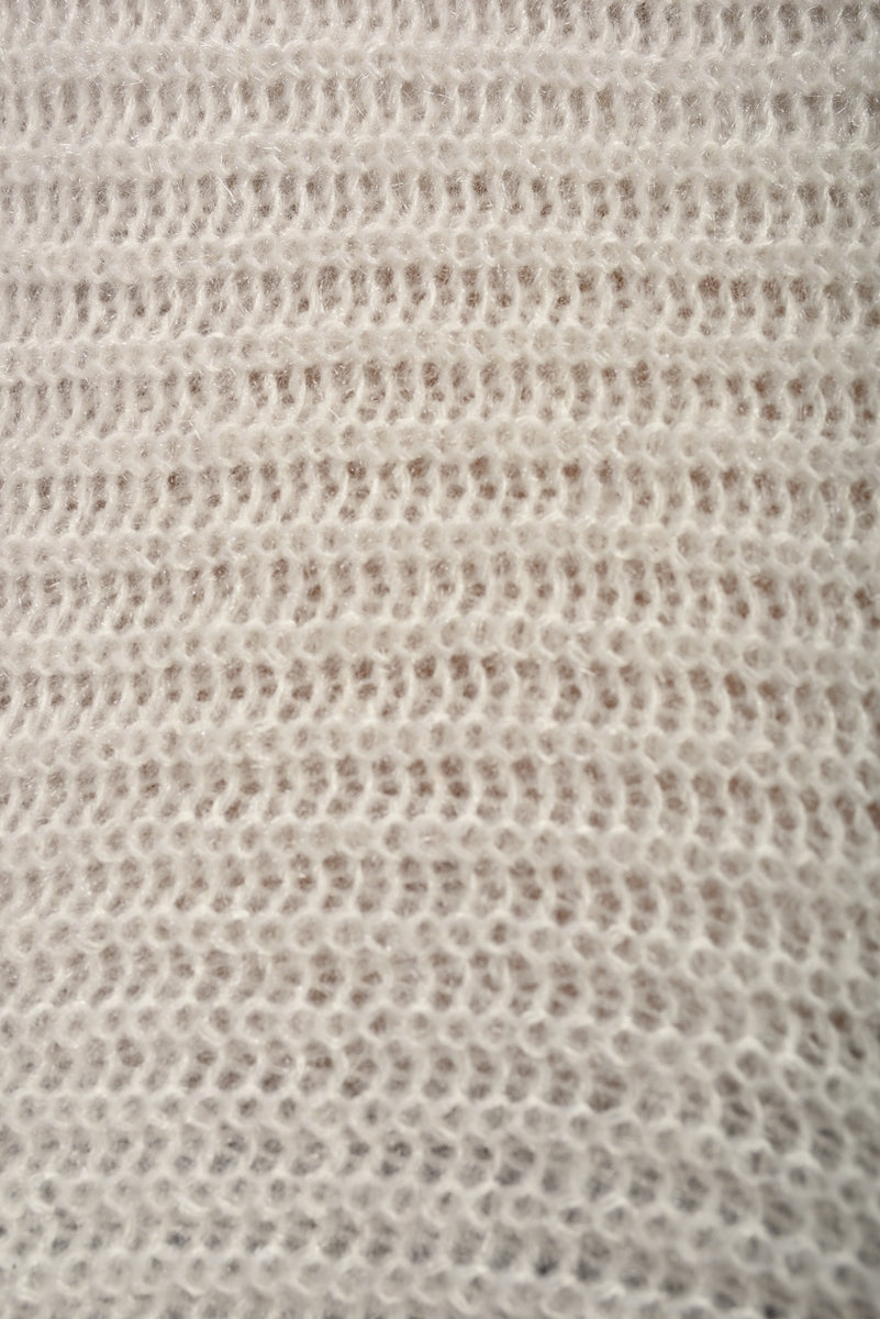 "Chunky knitted top with cut-out tie bow sleeve detail in beige, perfect for cozy winter wear."