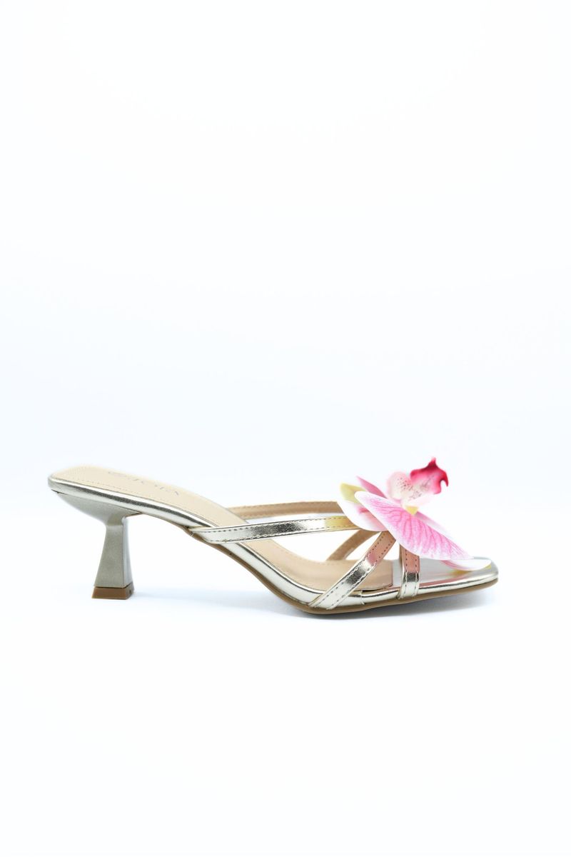 Floral strap high heel mule with pink flower accent and metallic upper, gold-toned block heel.