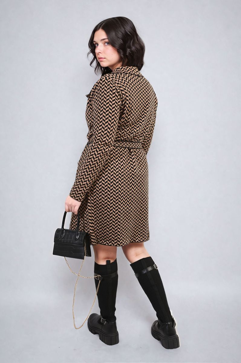 Woman wearing Belted coat with black boots and black handbag