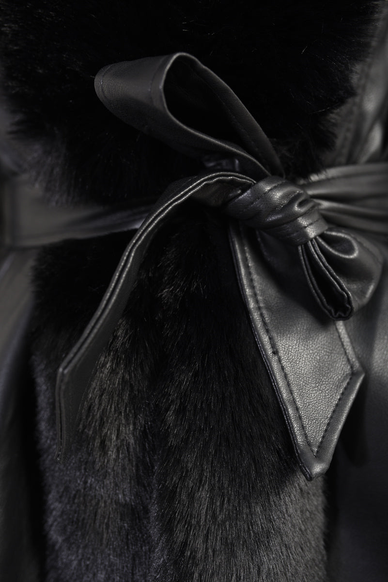 "Model wearing a faux fur trim winter jacket, ideal for cold weather fashion."