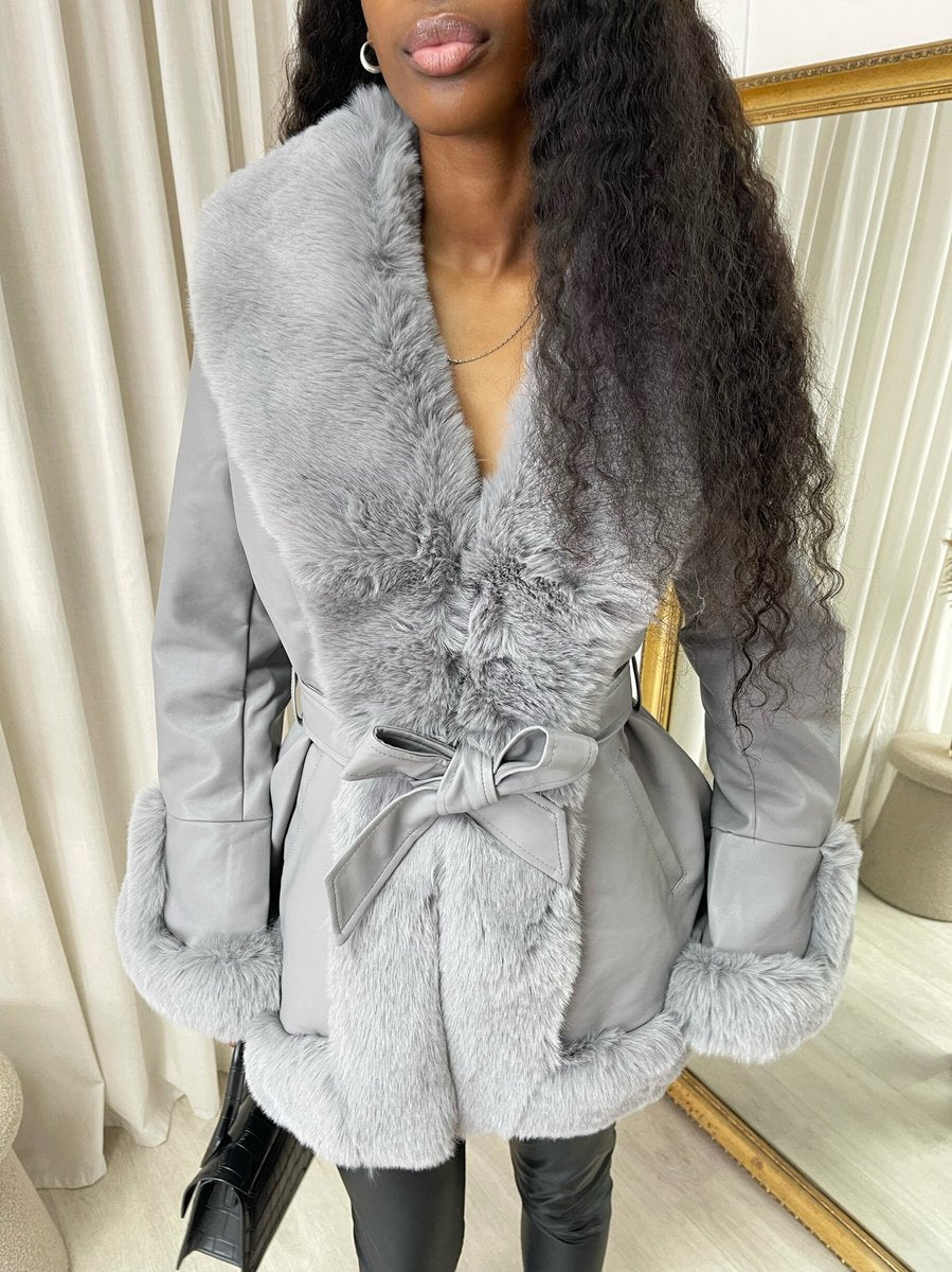 "Model wearing a faux fur trim winter jacket, ideal for cold weather fashion."