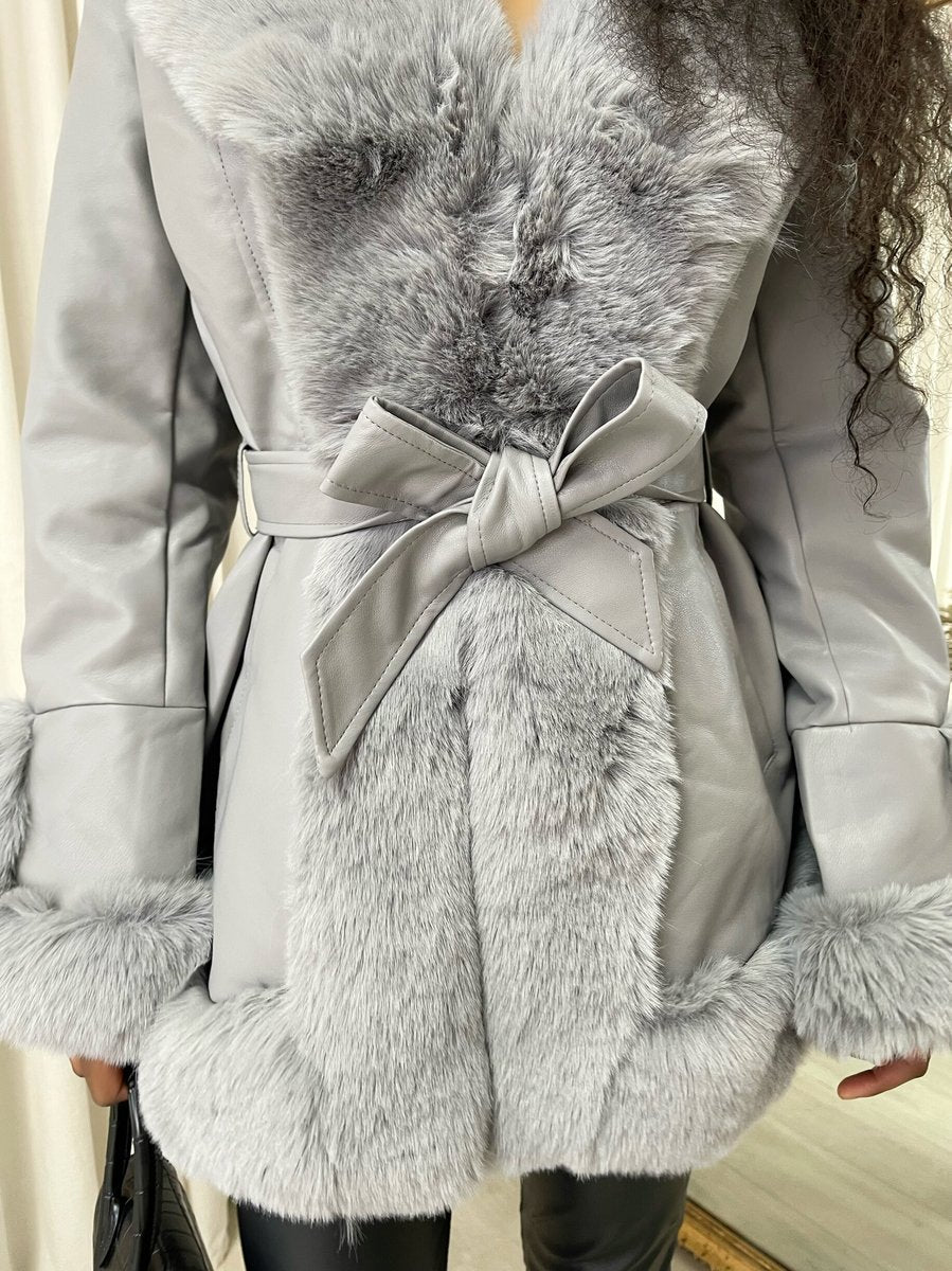 "Model wearing a faux fur trim winter jacket, ideal for cold weather fashion."