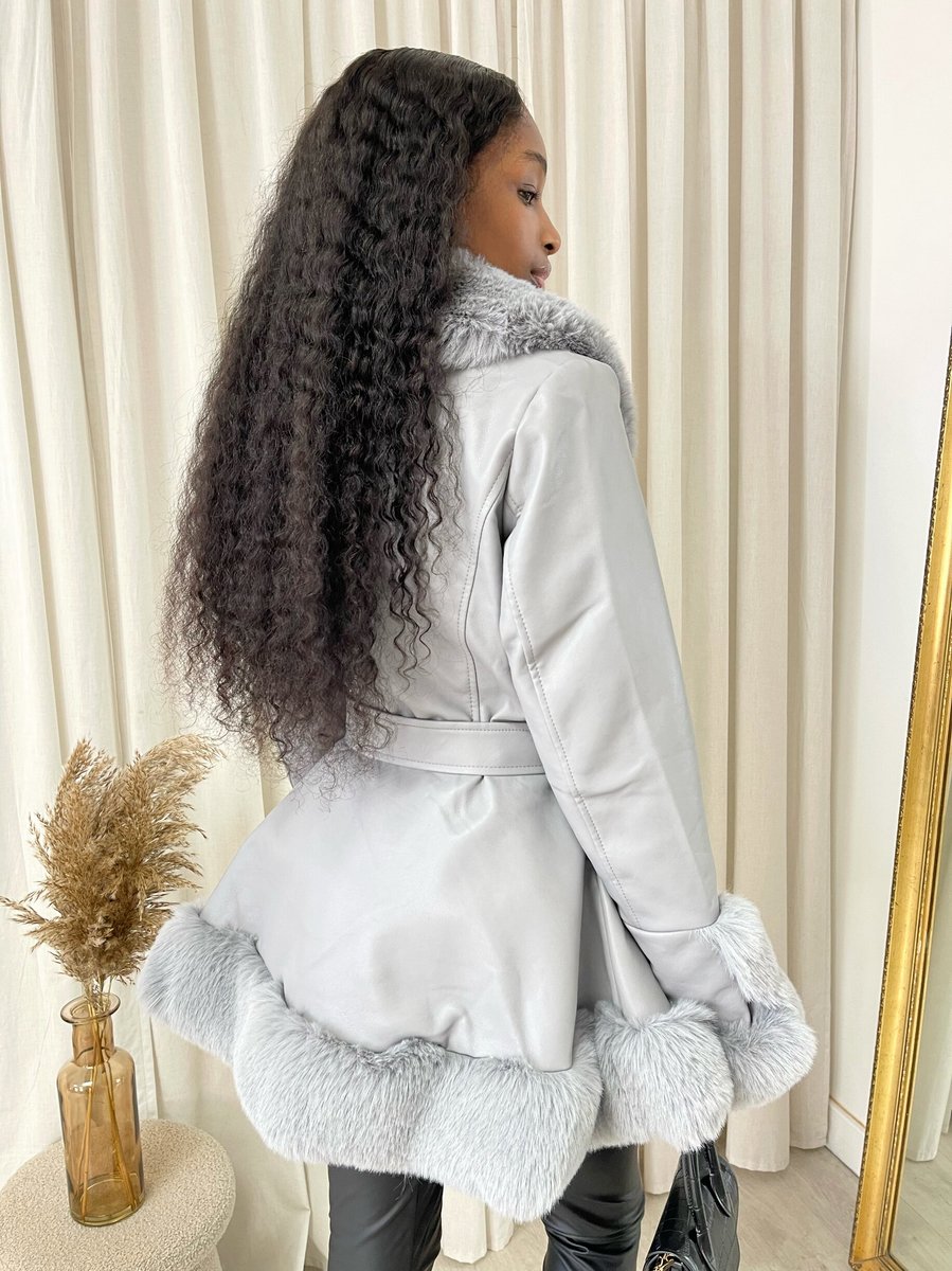"Model wearing a faux fur trim winter jacket, ideal for cold weather fashion."