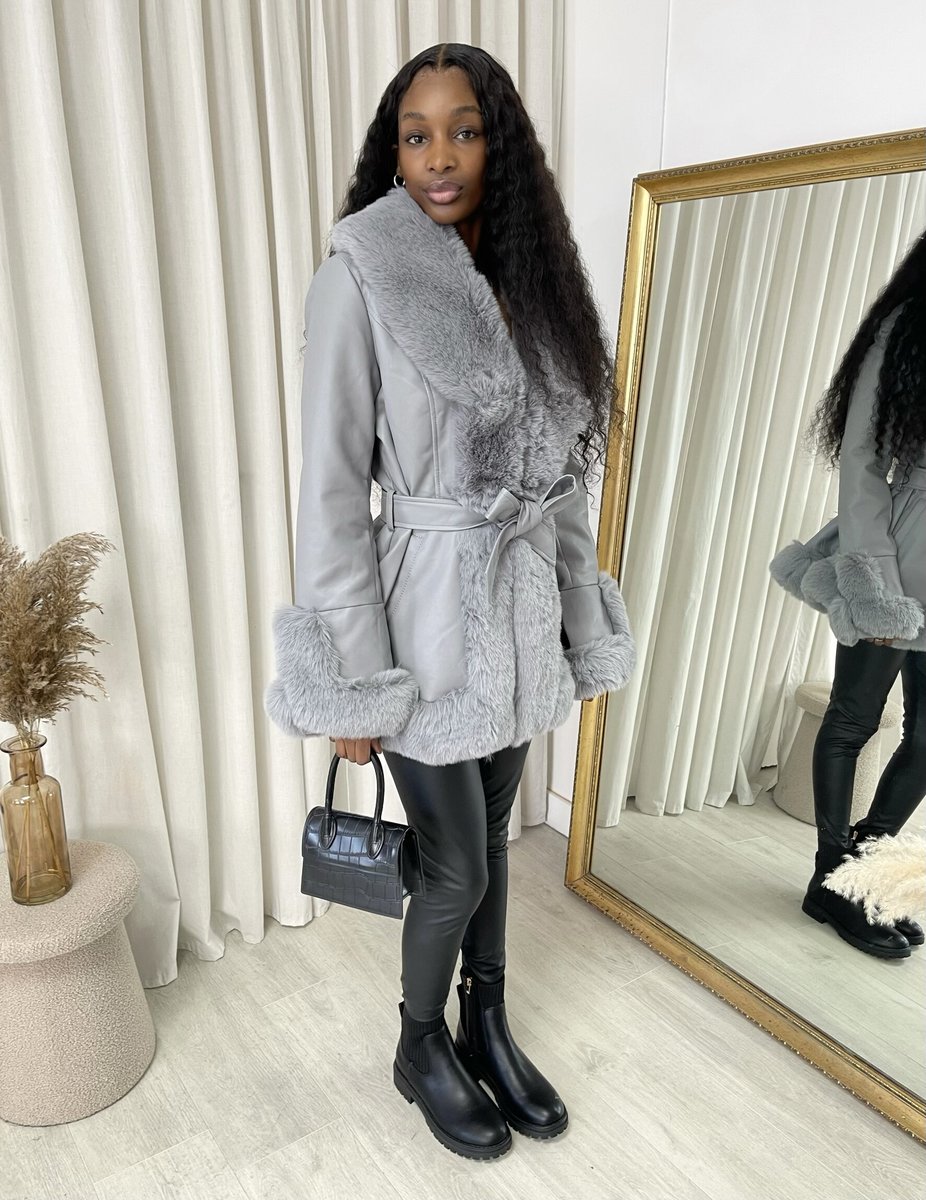 "Model wearing a faux fur trim winter jacket, ideal for cold weather fashion."