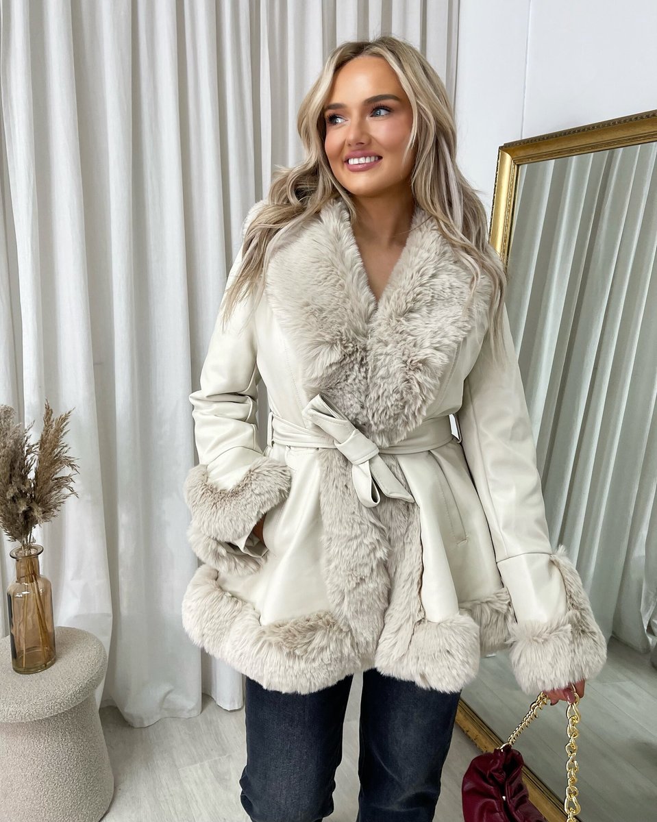 "Model wearing a faux fur trim winter jacket, ideal for cold weather fashion."