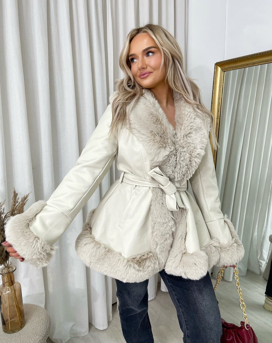 "Model wearing a faux fur trim winter jacket, ideal for cold weather fashion."