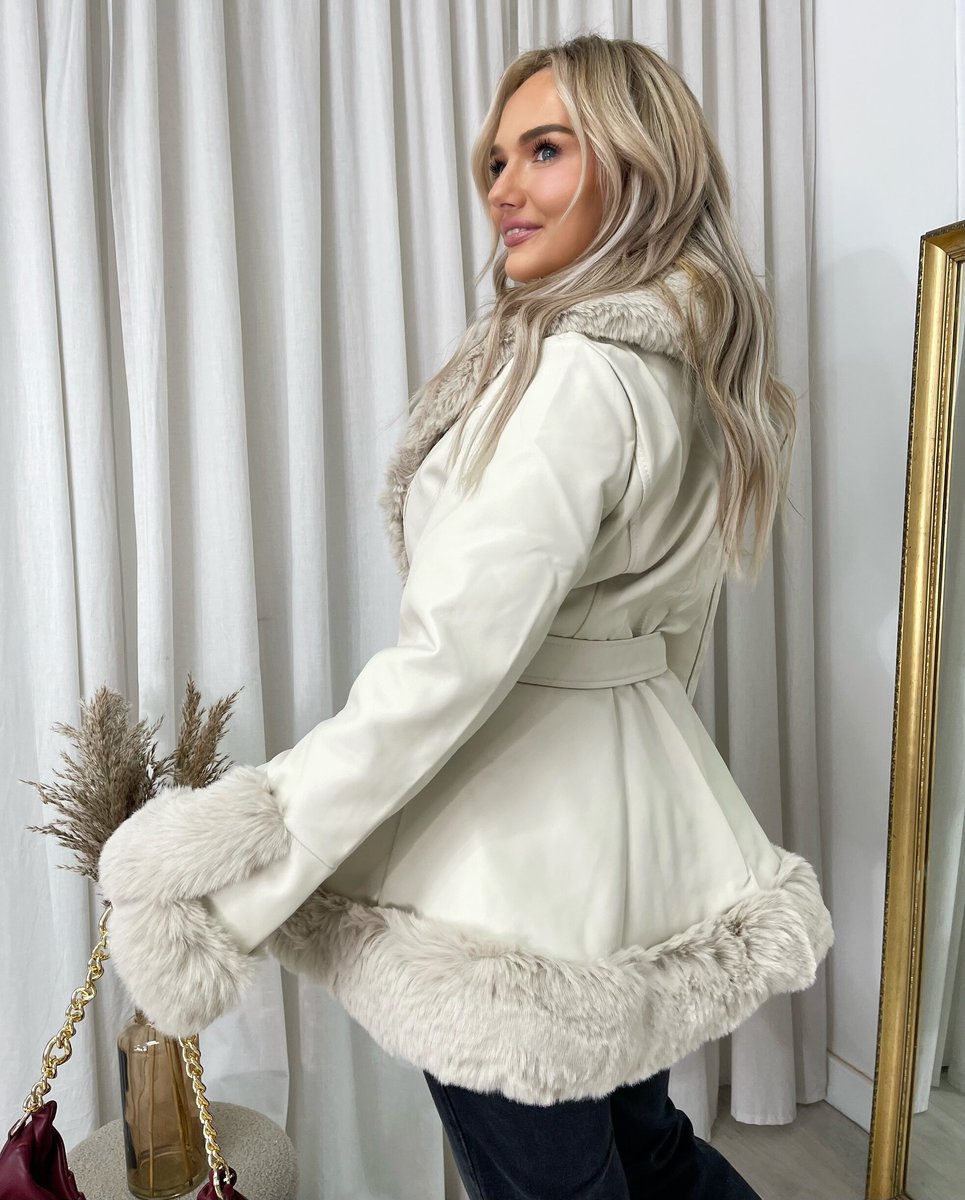 "Model wearing a faux fur trim winter jacket, ideal for cold weather fashion."