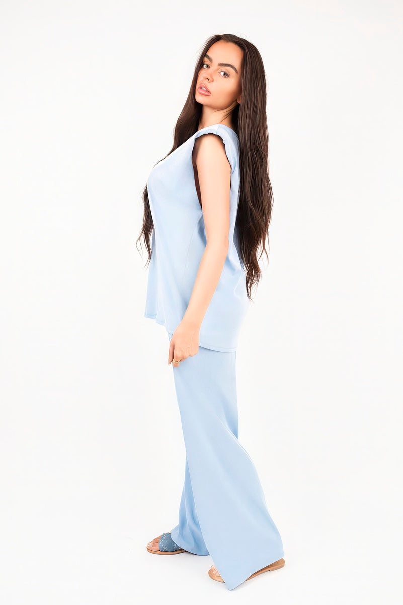 Light blue sleeveless relaxed top and wide-leg trousers set, profile view