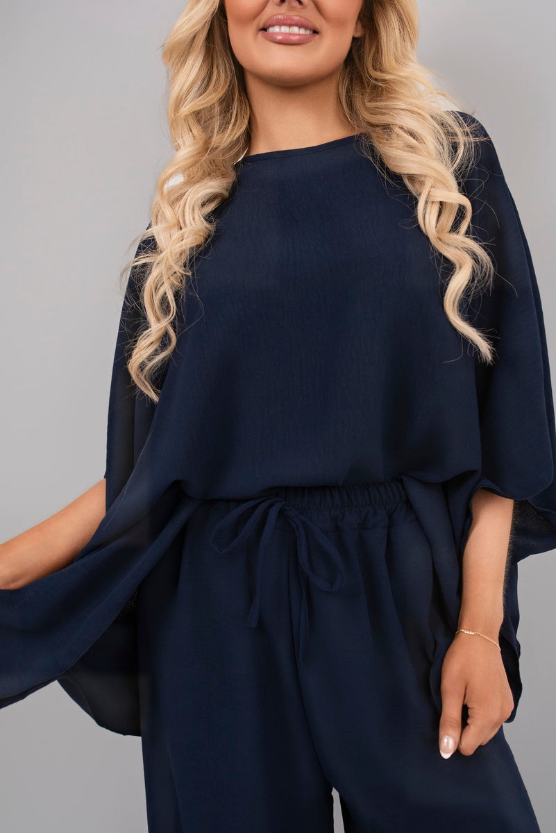 Navy batwing top with gathered drawstring waist and flowing sleeves