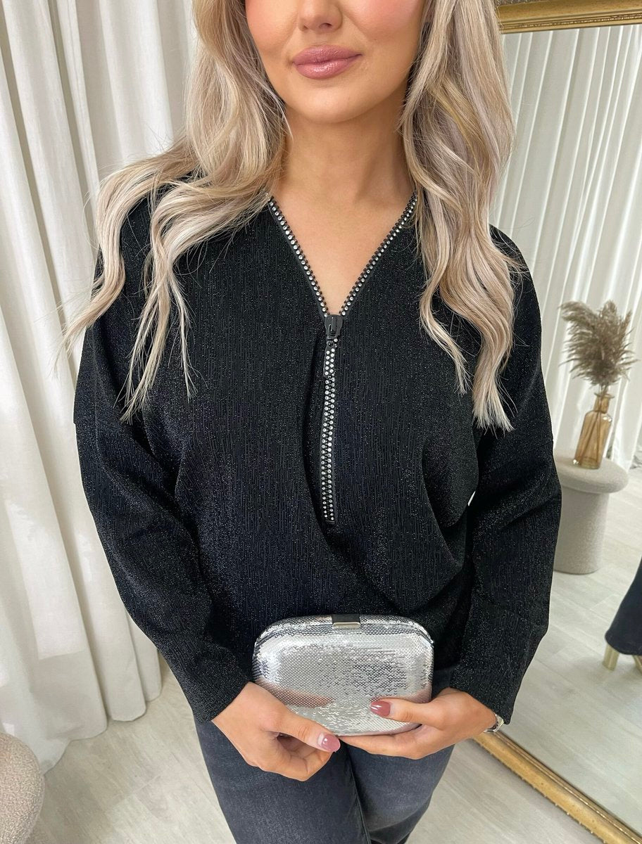"Front Zip Detail Glitz Top with a shimmering finish, featuring a sleek zip design for a stylish and versatile look."