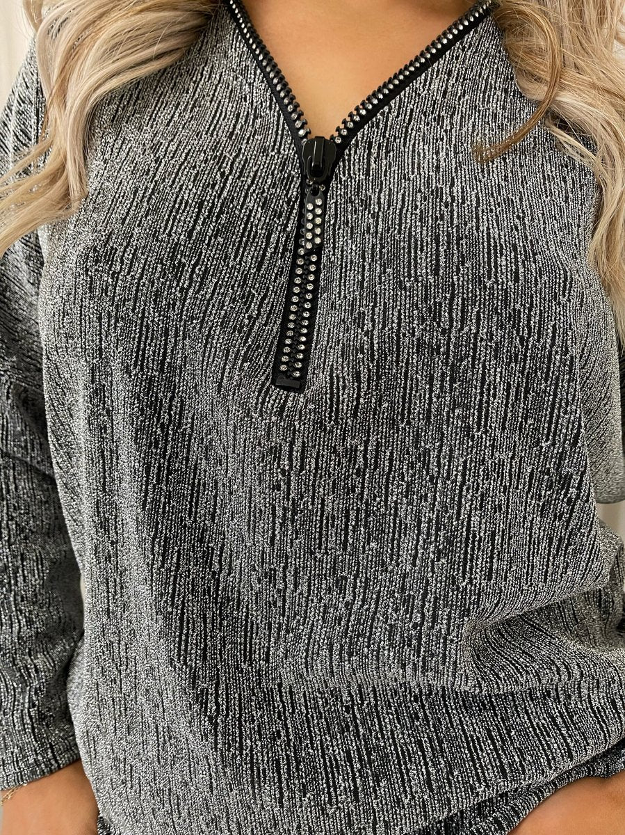 "Front Zip Detail Glitz Top with a shimmering finish, featuring a sleek zip design for a stylish and versatile look."
