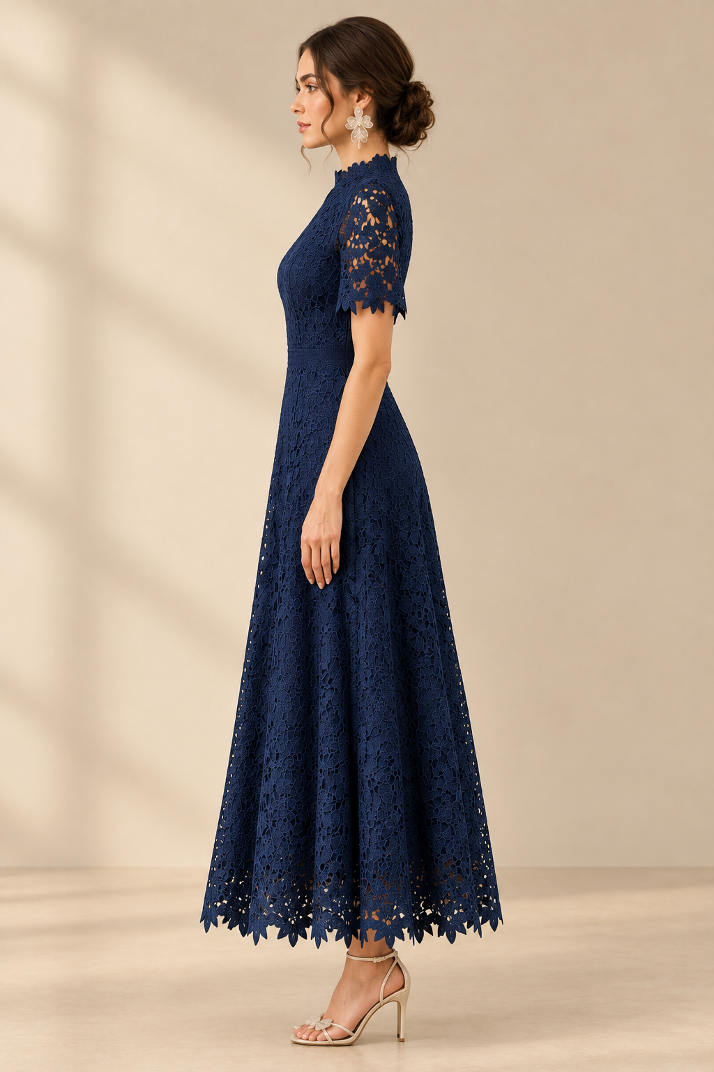 Full-length side view of the navy floral embroidered lace dress, showing the fitted waist, scalloped short sleeve and ankle-length full skirt.