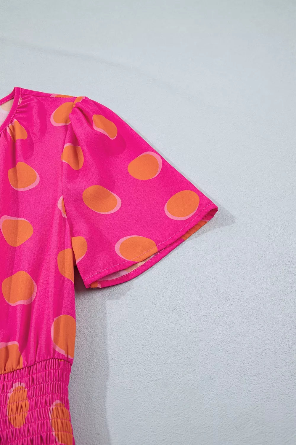 Hot pink polka dot short-sleeve dress with V-neck and gathered waist