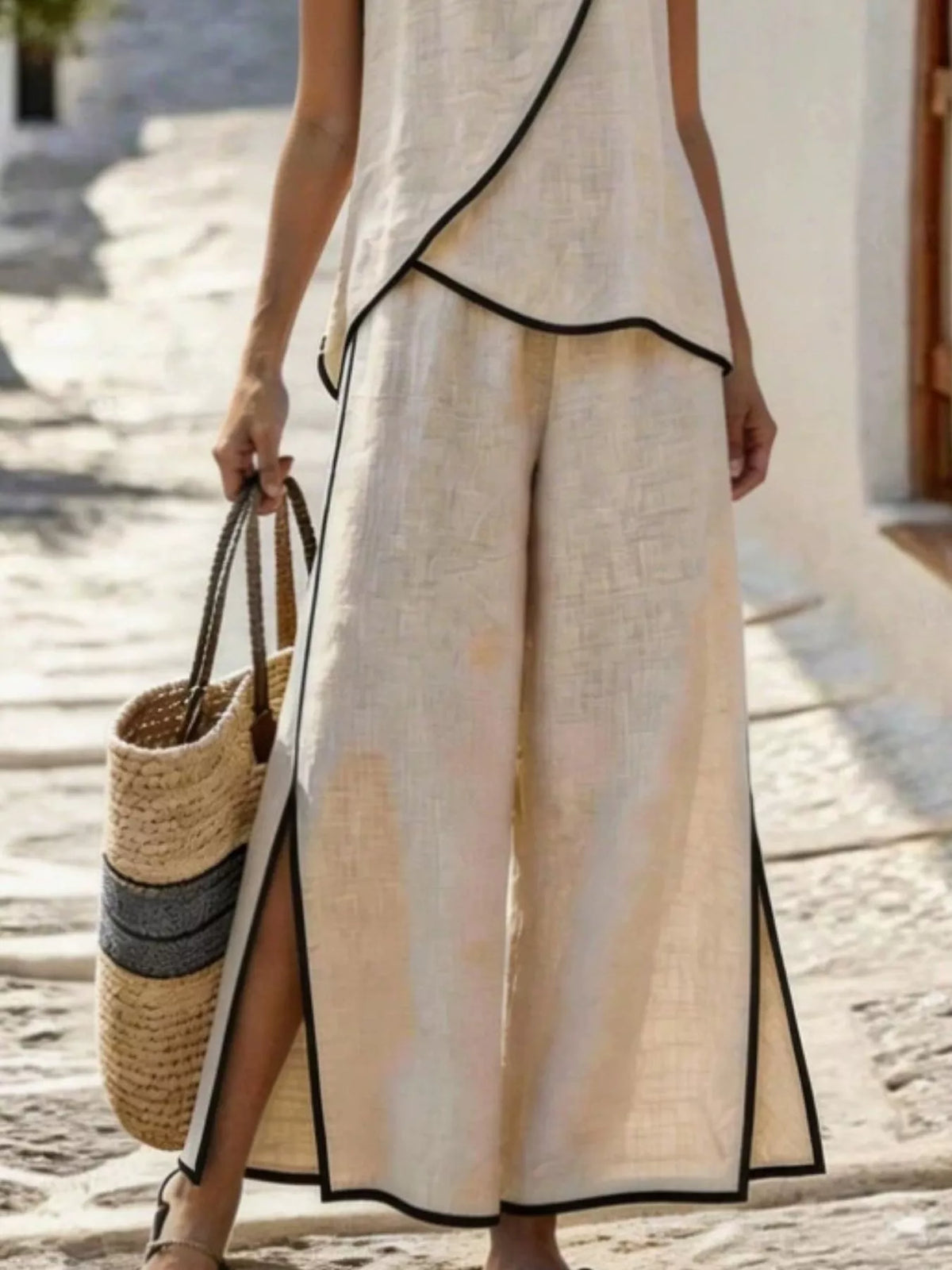 Light apricot two-piece set with sleeveless top and wide-leg slit pants, black trim