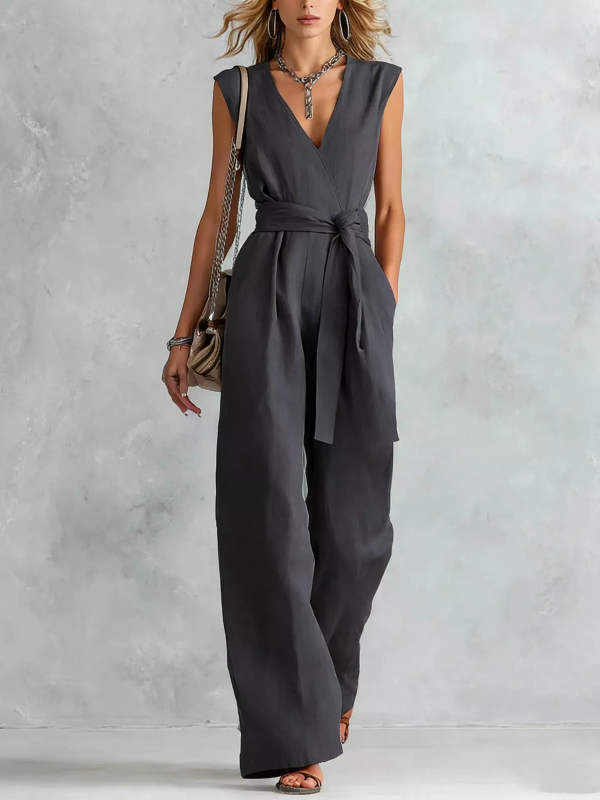Sleeveless wide-leg jumpsuit in charcoal gray with V-neck and waist tie belt