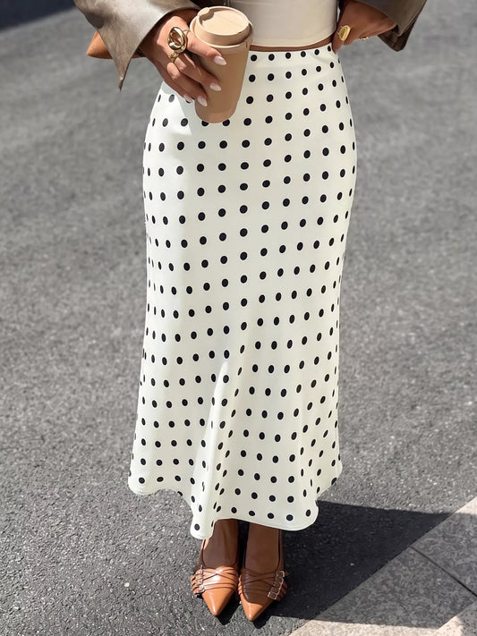 Cream polka dot midi skirt with black dots, fitted waistband and A-line drape