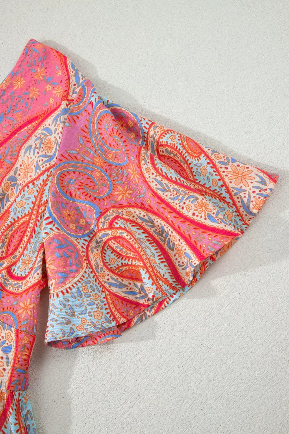 Burnt coral paisley print boho dress sleeve and skirt ruffles, side view