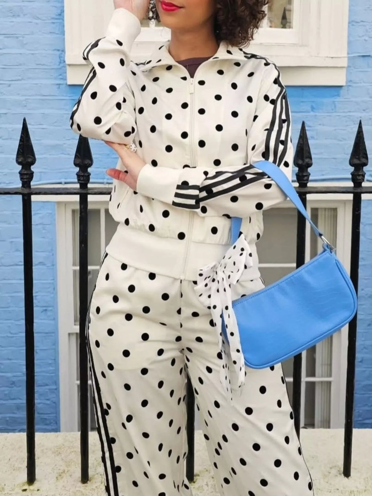 White polka-dot zip-up jacket and matching pants set with black sleeve stripes