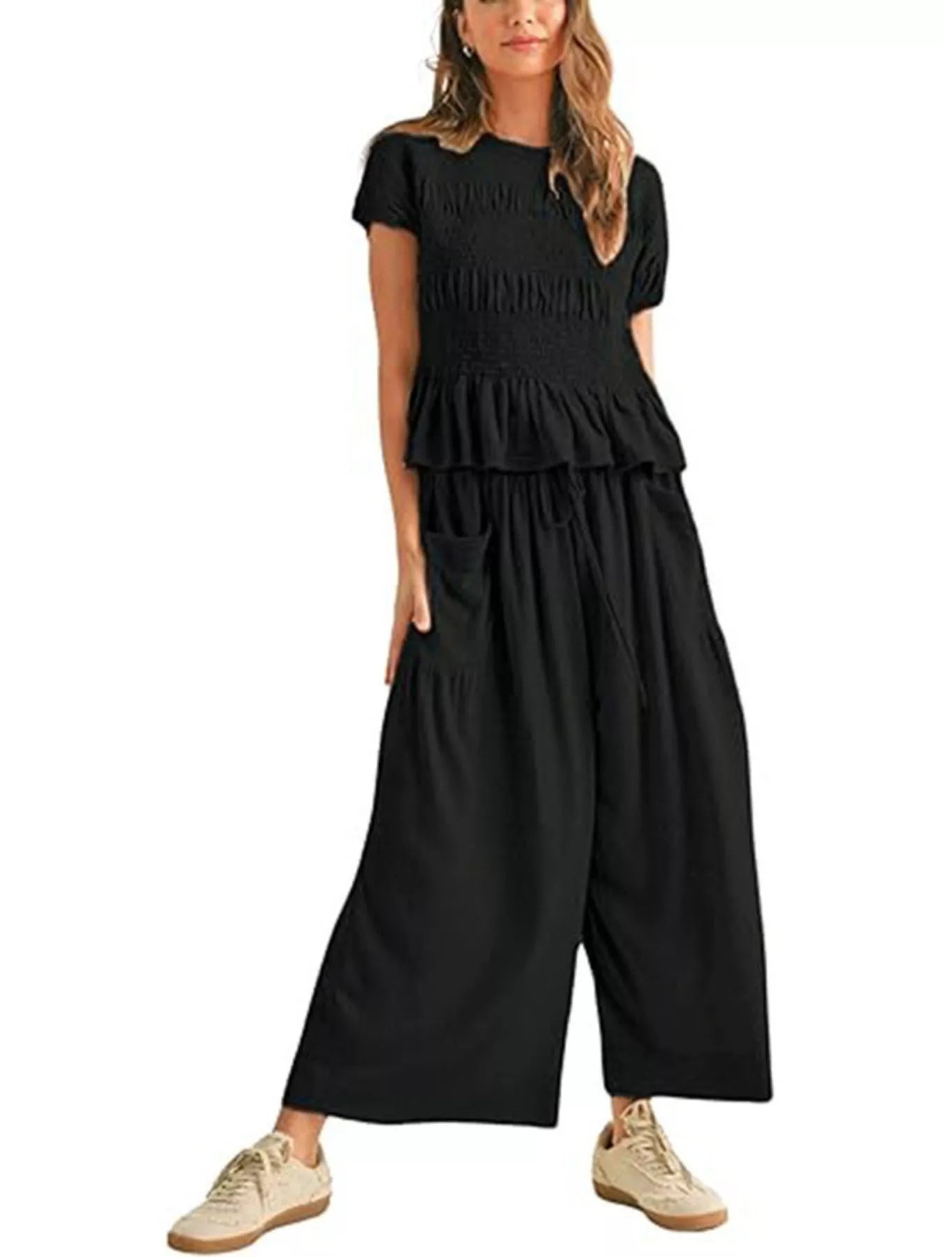 Black smocked peplum top and wide-leg pants set, short sleeves, tiered peplum.