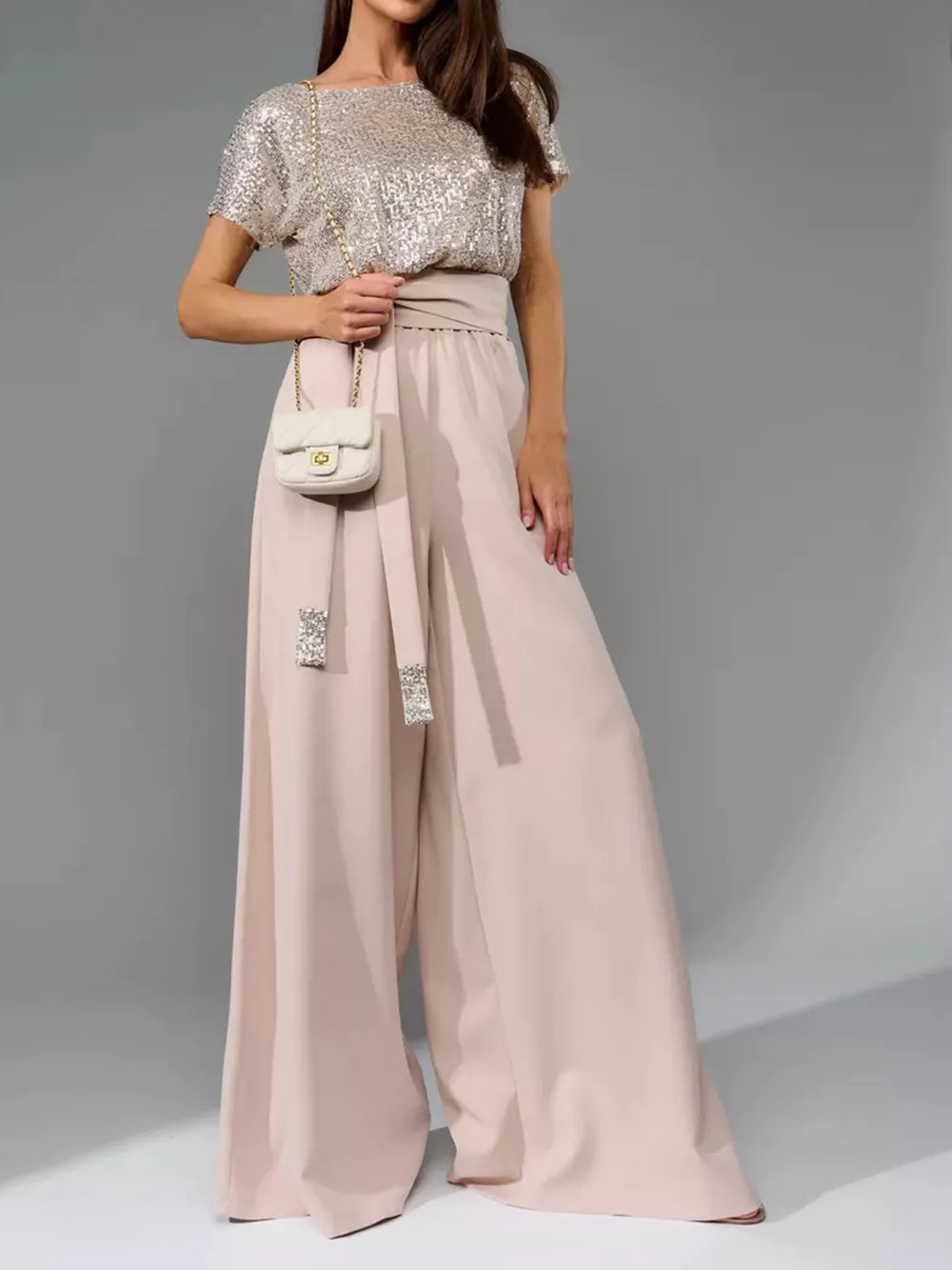 Silver sequin top and blush wide-leg jumpsuit, short sleeves and round neckline