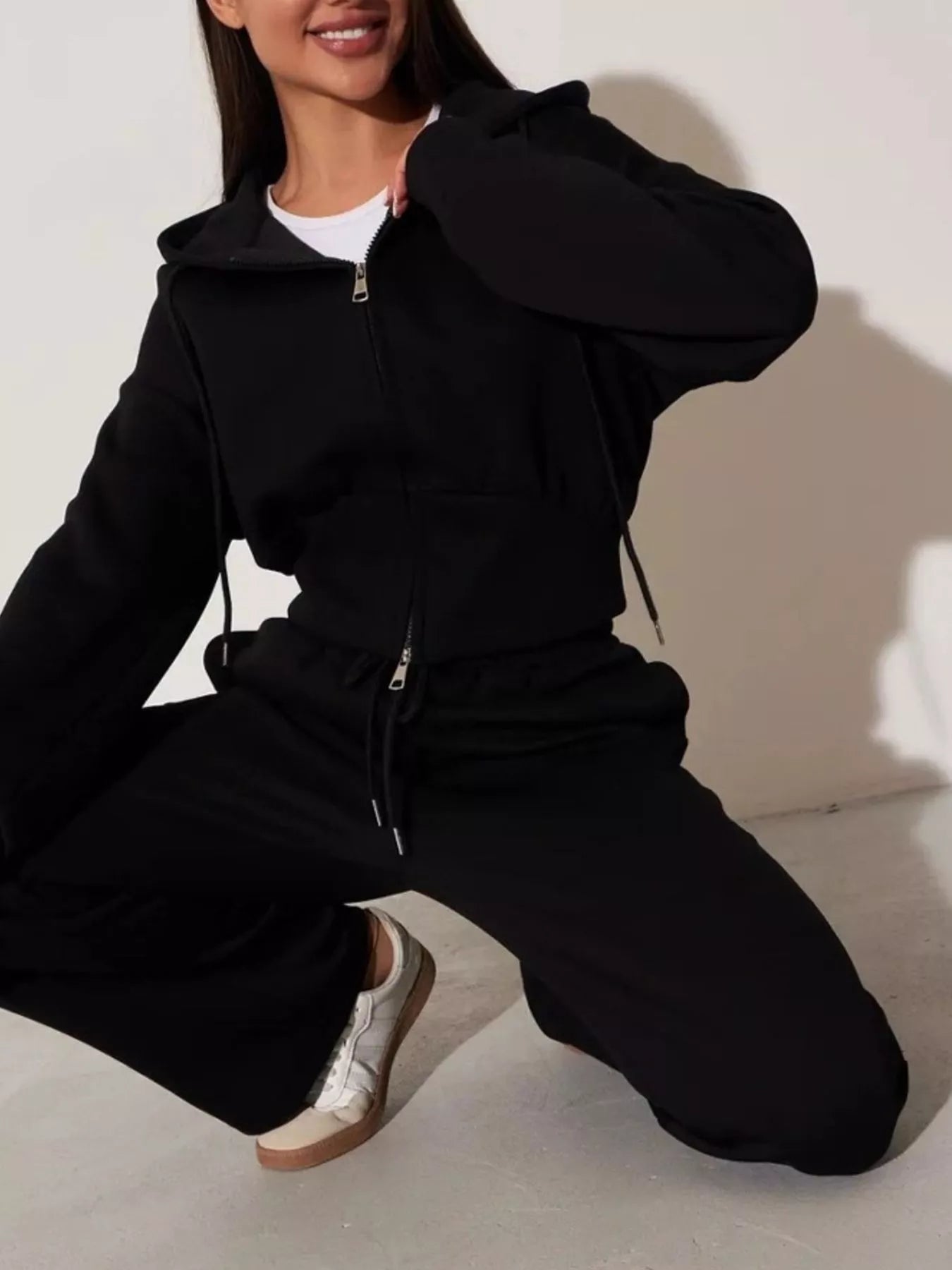 Black zip-up hoodie and wide-leg pants set with hood and front zipper, long sleeves