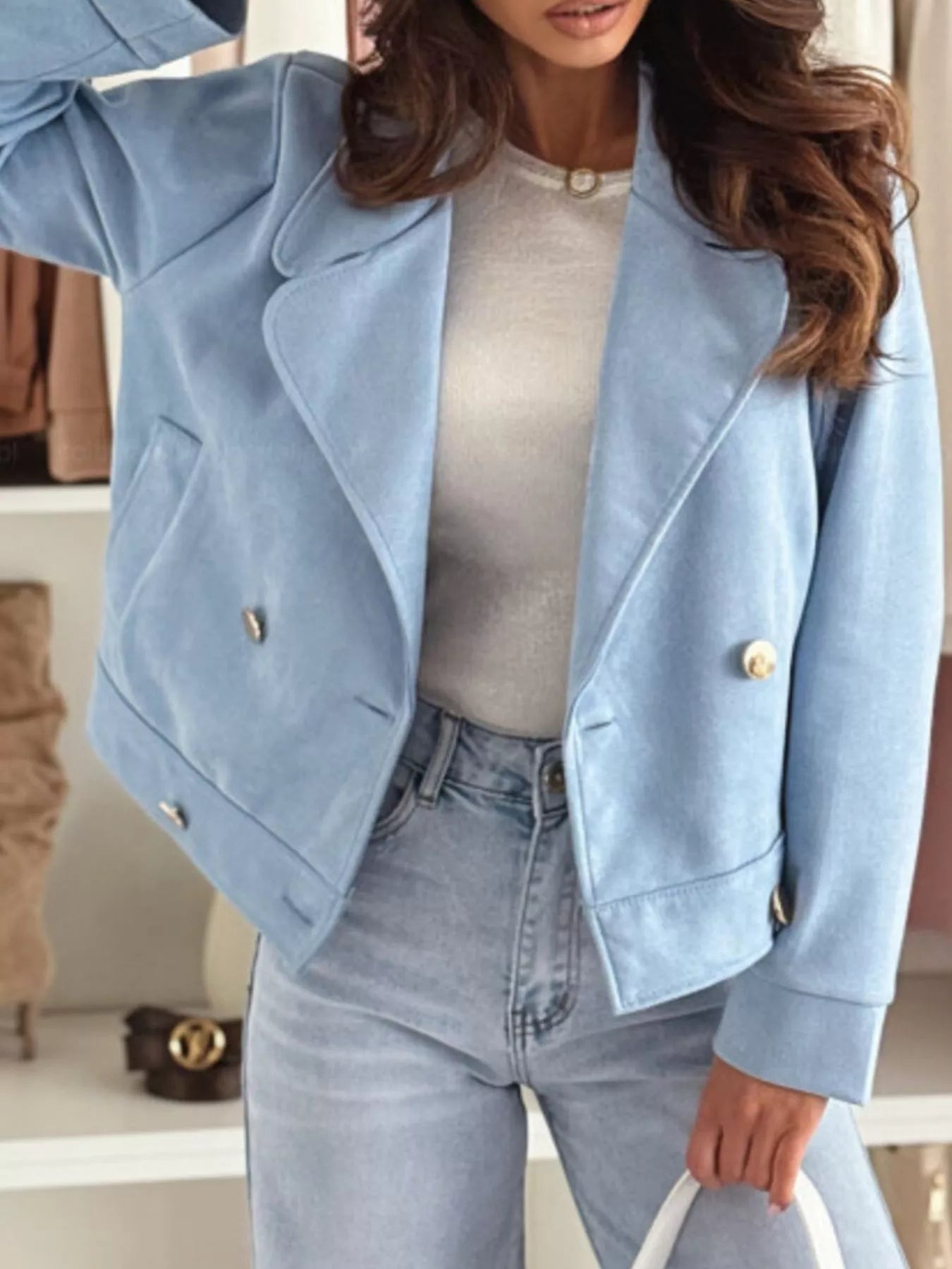 Light blue cropped double-breasted jacket with gold buttons and flap pockets