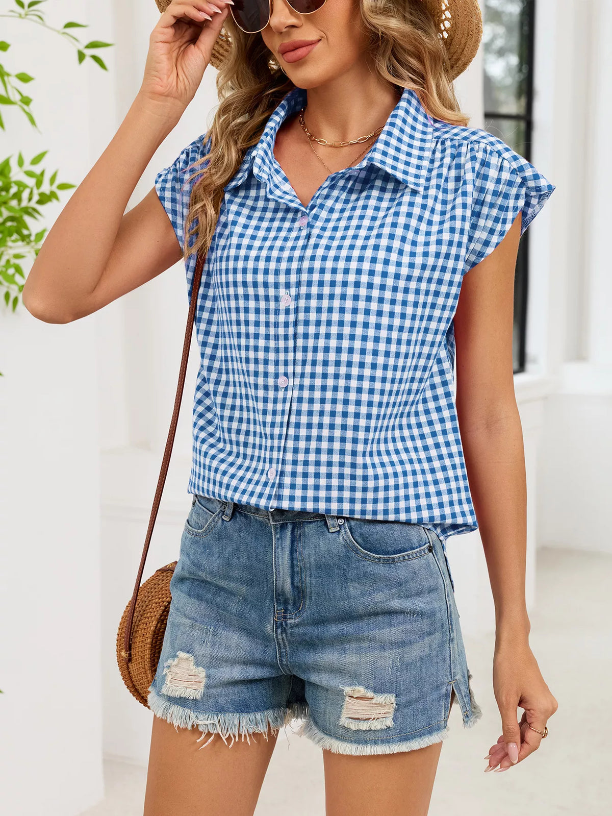 Blue plaid button-up cap sleeve shirt with collar and front button closure