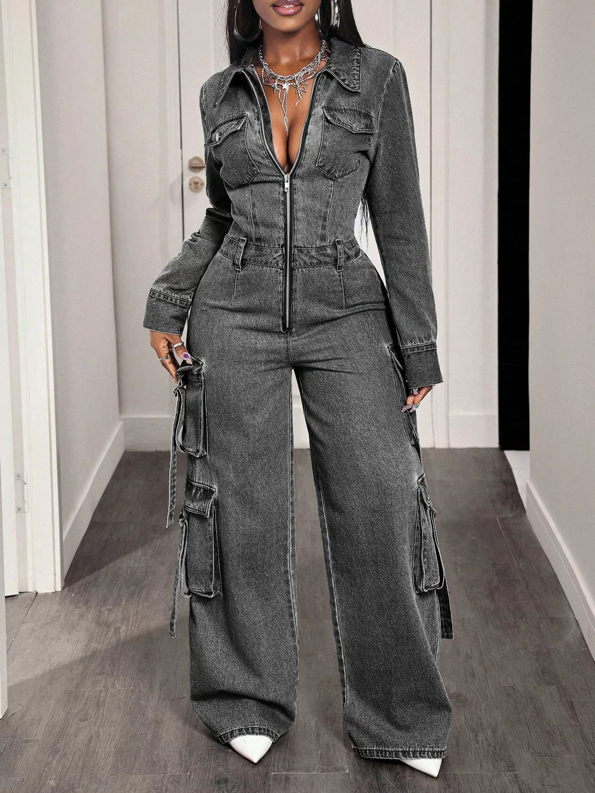 Gray denim zip-front cargo jumpsuit with front flap pockets and long wide-leg silhouette