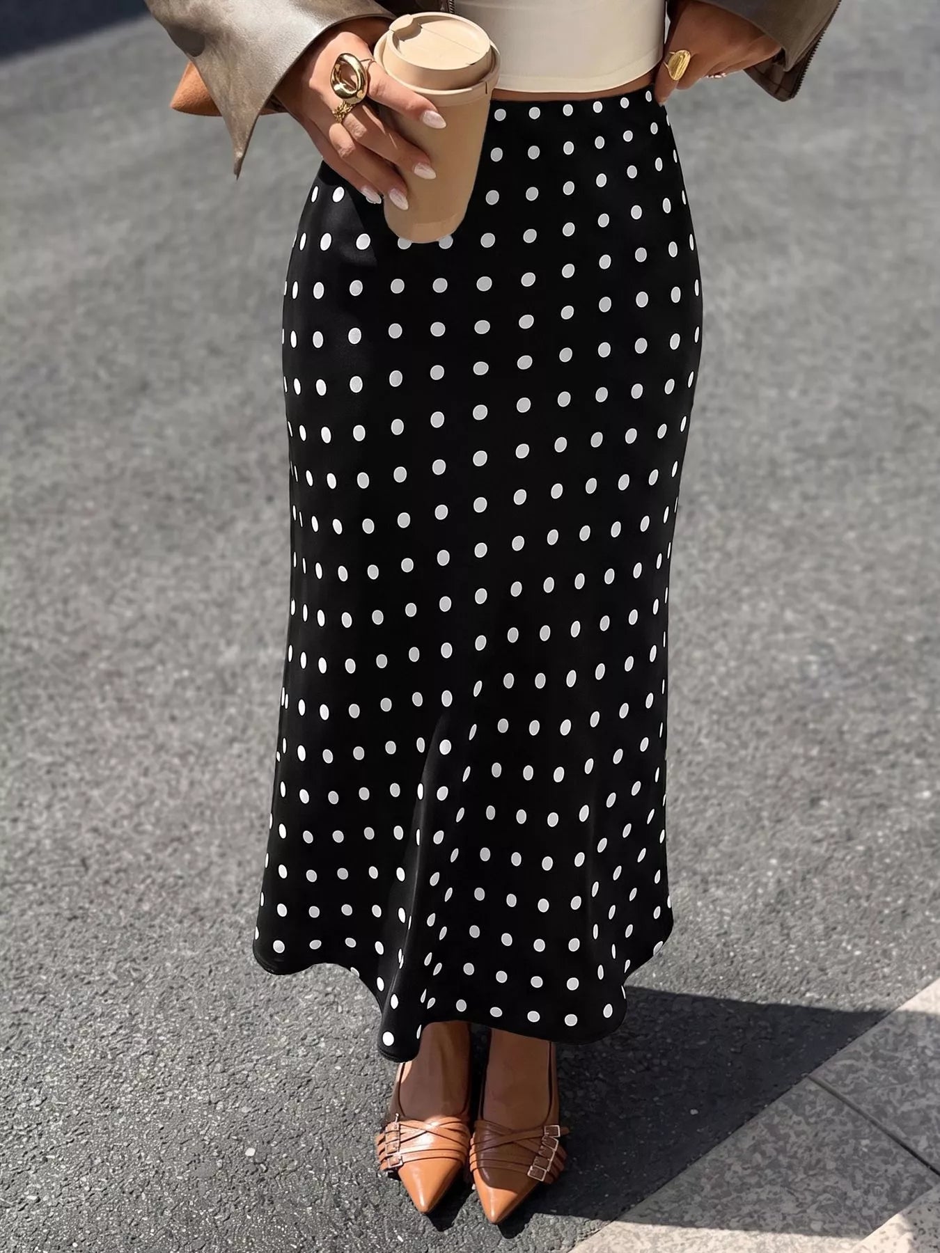 Black midi skirt with white polka dots and straight, full-length cut