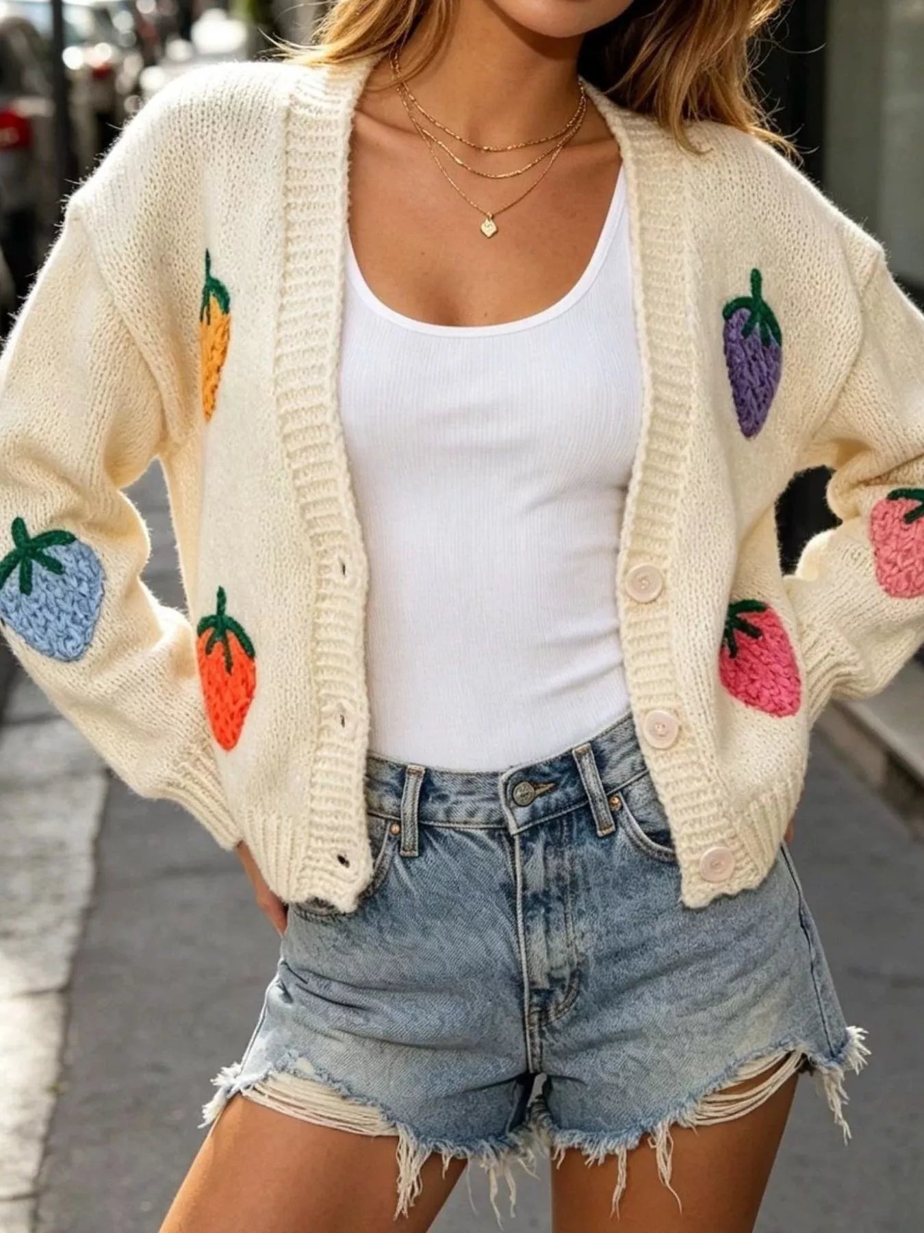 Cream knit cardigan with colorful fruit applique patches and button-front