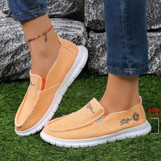 Orange raw-edge round-toe slip-on sneaker with embroidered detail and white sole