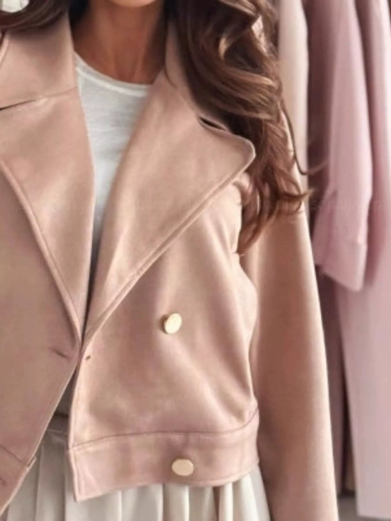 Blush pink cropped double-breasted jacket with gold button closure and flap pockets