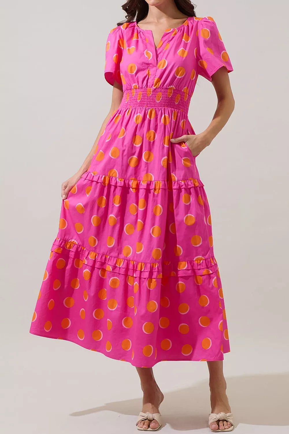 Hot pink polka dot tiered midi dress with smocked waist and flutter sleeves
