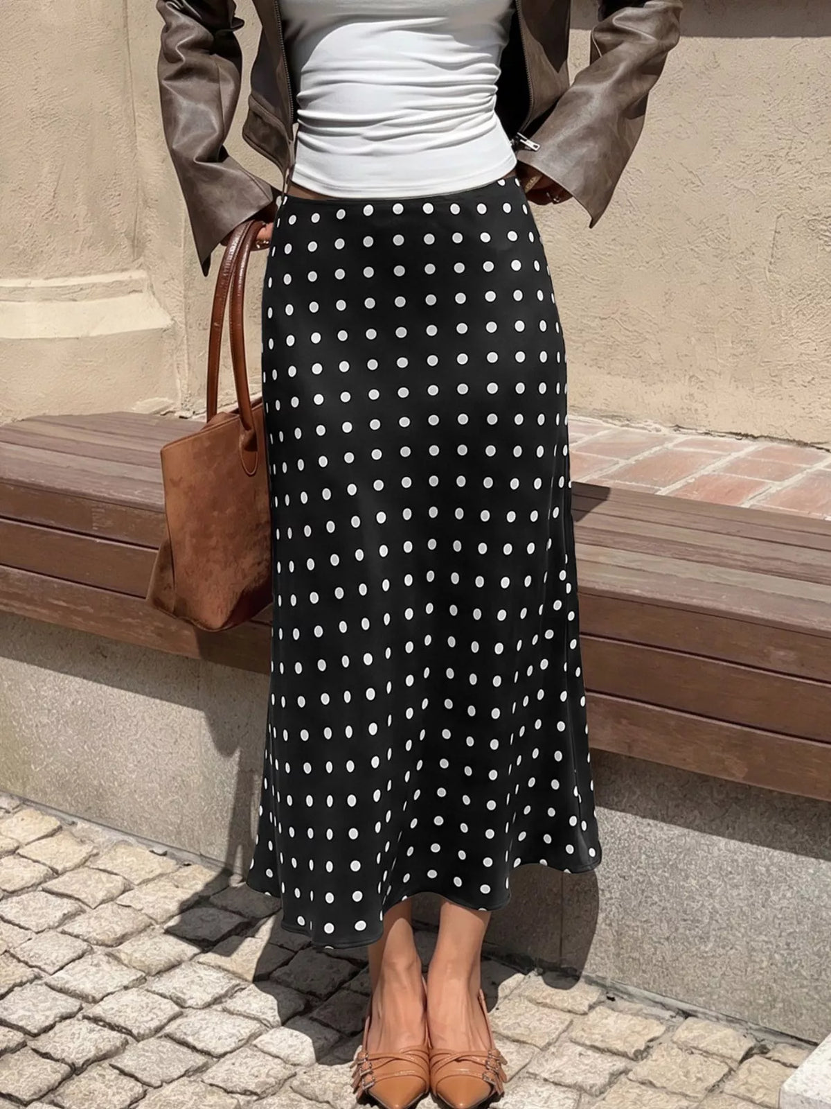 Black midi skirt with white polka dots, long flared silhouette
