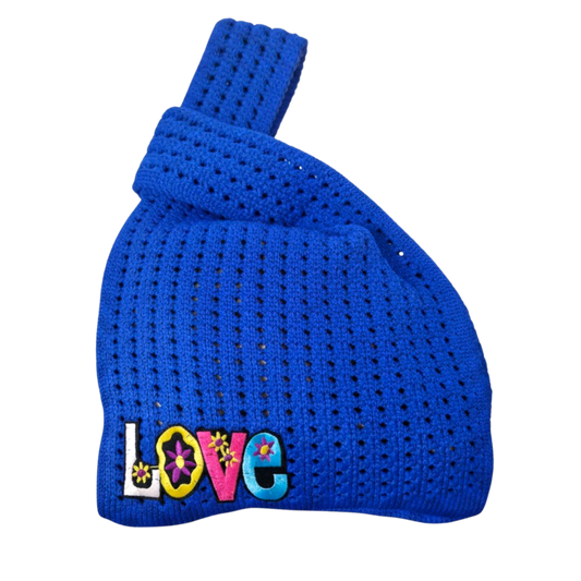 Bright blue crocheted knot wrist bag with colorful LOVE appliques on front