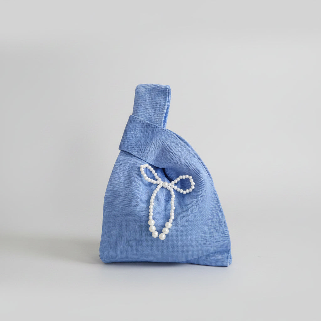 Blue satin knot wrist bag with white pearl bow and teardrop dangle embellishment