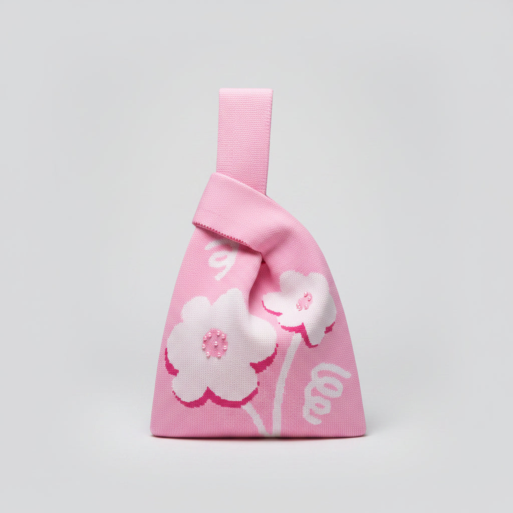 Knot wrist bag in light pink with floral print and ribbon wrist strap