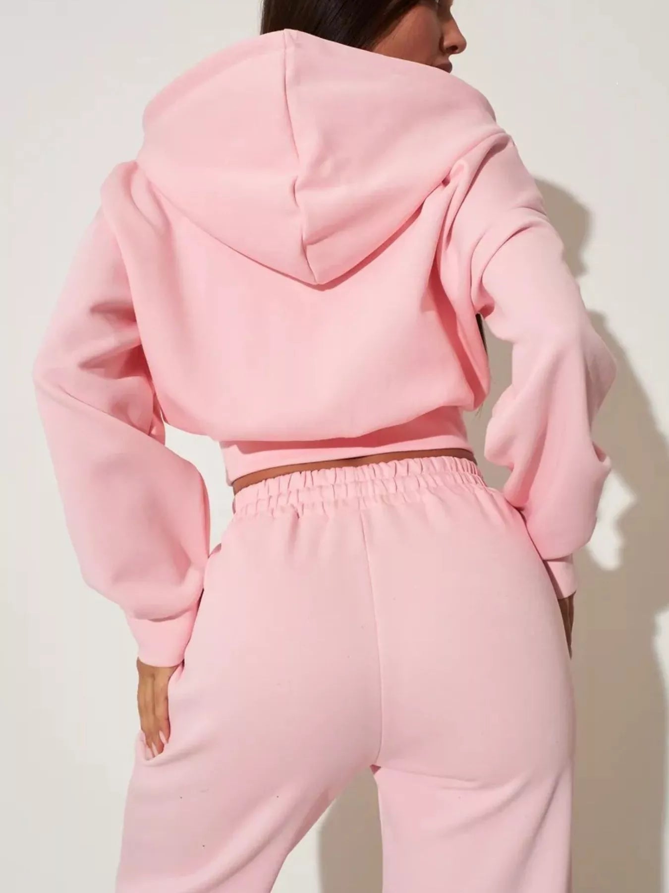 Pink zip-up hoodie and wide-leg pants set, back view with hood and elastic waist