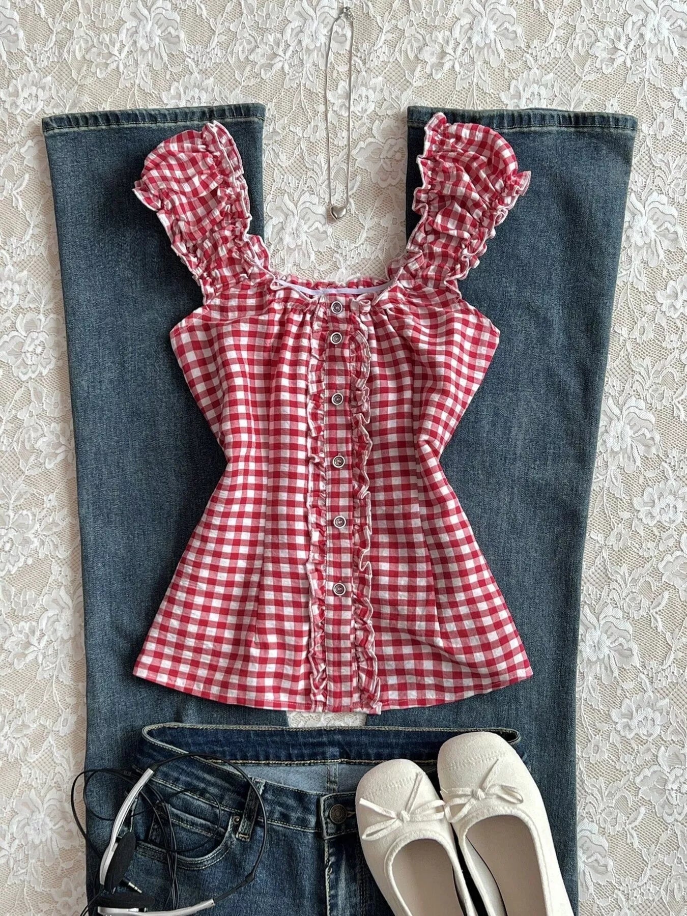 Red gingham blouse with frilled cap sleeves, button placket, and lace-up front detail