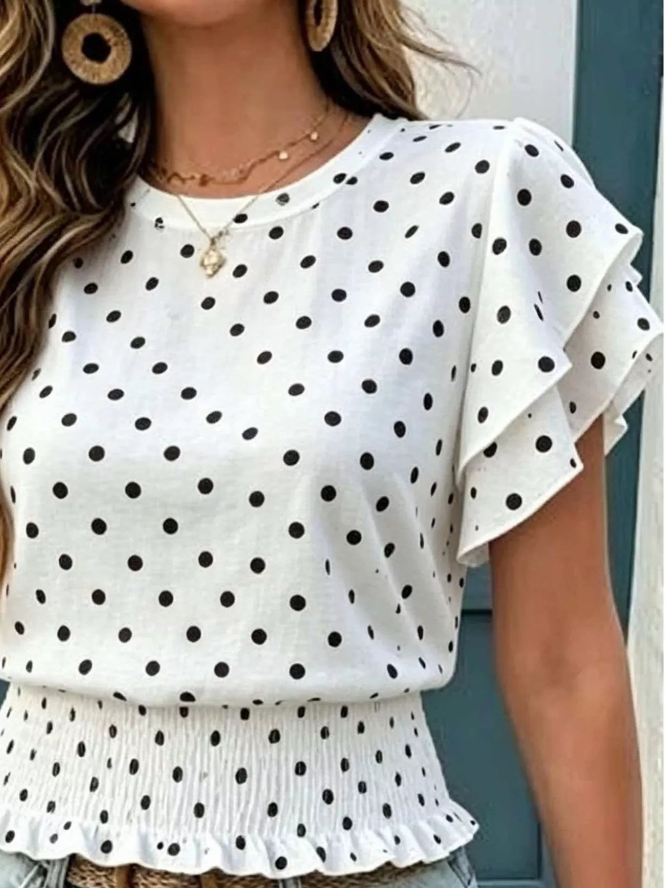 White polka dot blouse with tiered peplum hem and wide ruffle sleeves