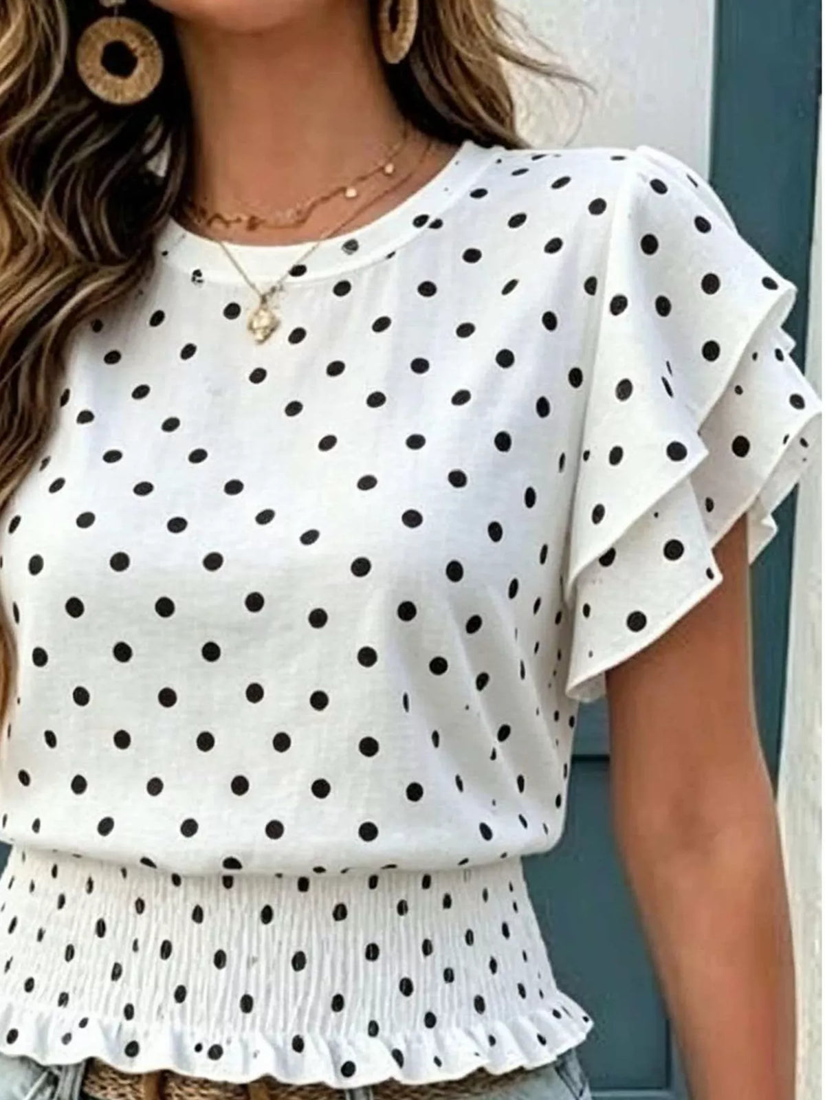 White polka dot blouse with tiered peplum hem and wide ruffle sleeves