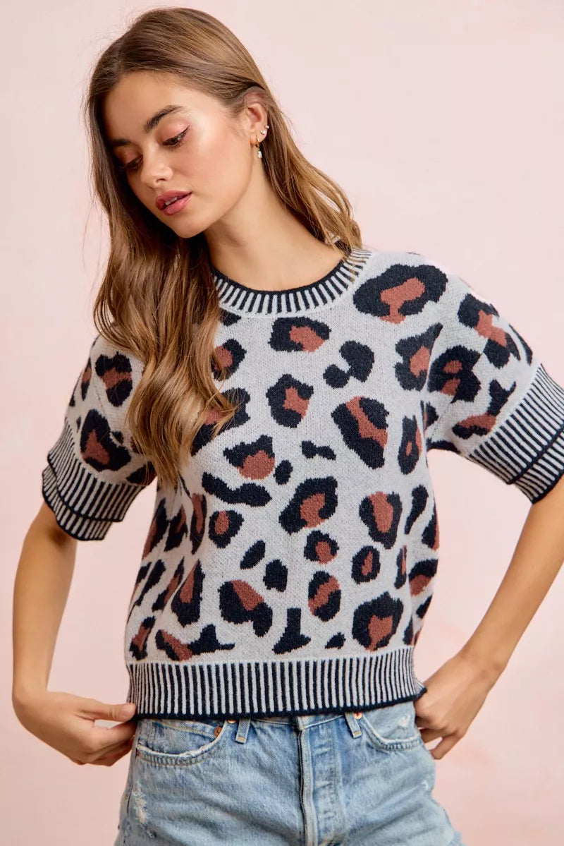 Leopard print knit top with striped crew neckline and short sleeves; front view.